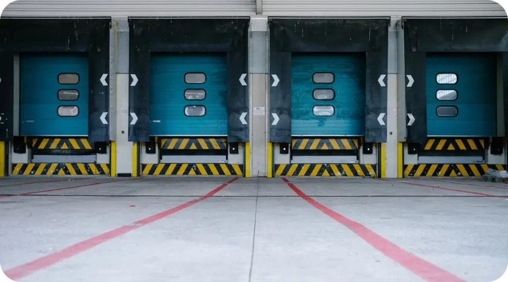 Warehouse loading dock with roller doors for import and export