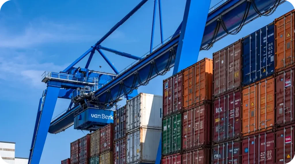 Port crane loading shipping containers for logistics services