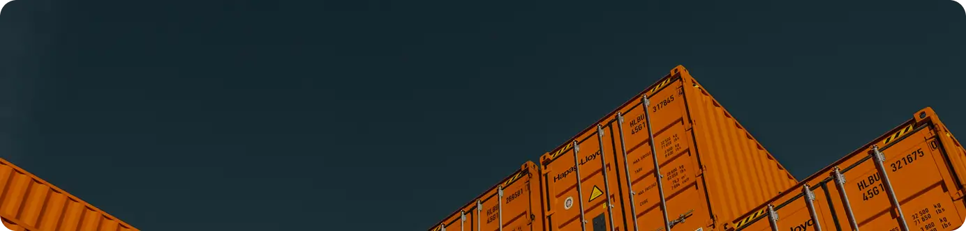 Stacked orange shipping containers representing TechGen Global services
